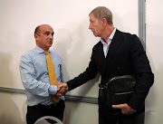 Stuart Baxter shakes hands with SA Football Association acting chief executive Russell Paul resigning as Bafana Bafana head coach during a press conference in Killarney, Johannesburg, on Friday August 2 2019.    