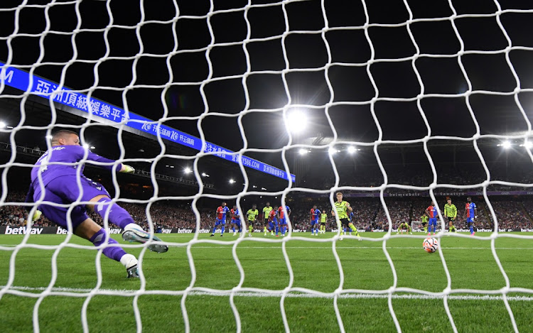 Martin Odegaard of Arsenal scores a penalty past Sam Johnstone of Crystal Palace for the team's lone goal in their Premier League win at Selhurst Park in London on August 21 2023.