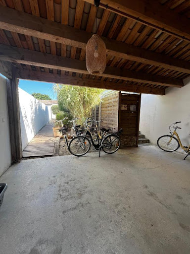 Bicycles parked under wooden porch in this luxury villa for sale in Rivedoux-Plage ($1,461,175 - 137 m²)