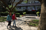 People walk past a banner with images of hostages kidnapped in the deadly October 7 attack on Israel by the Palestinian Islamist group Hamas, in Tel Aviv, Israel, on April 16 2024.