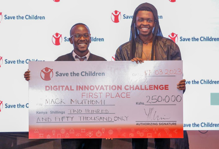 From left, Mack Muthomi and Alex Mwaniki of Toto Register pose for a photo with the awarded dummy cheque during the award ceremony