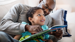 image of man and young boy reading