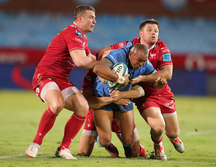 Cornal Hendricks of the Bulls challenged by Steff Evans (l) of the Llanelli Scarlets during their United Rugby Championship match at Loftus.