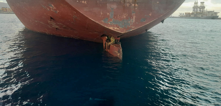 Three stowaway migrants are seen on the rudder blade of petrol vessel Althini II after traveling from Nigeria and before being rescued by Spanish coast guard near Las Palmas de Gran Canaria port, in the Canary Islands, Spain on November 28, 2022.