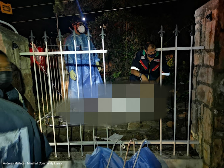 Paramedics treat a man who was impaled when he fell on a palisade fence in Durban.