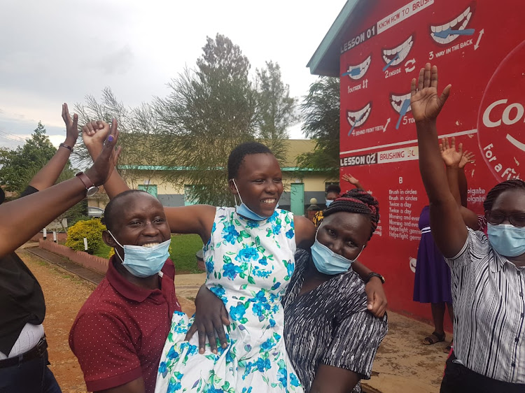 Angel Gakenia of Maseno Girls Boarding primary school in Kisumu is carried shoulder high after she scored 432 marks out of 500 in KCPE/MAURICE ALAL