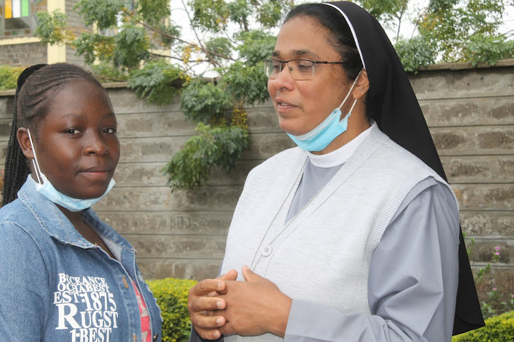 Marion Ondisa with Brigida Morello Girls Secondary school principal Sister Sweta Abraham at the institution in Katani, Machakos County on Friday, May 14.