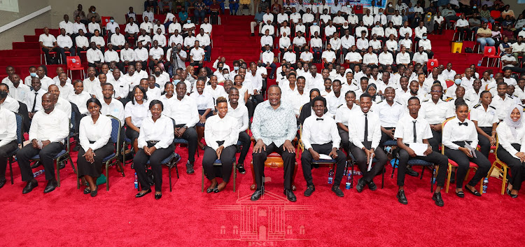 President Uhuru Kenyatta poses for a photo with the 350 new seafarers during the flag off ceremony at the Kenya Maritime Academy in Mombasa County on Thursday, August 4,2022