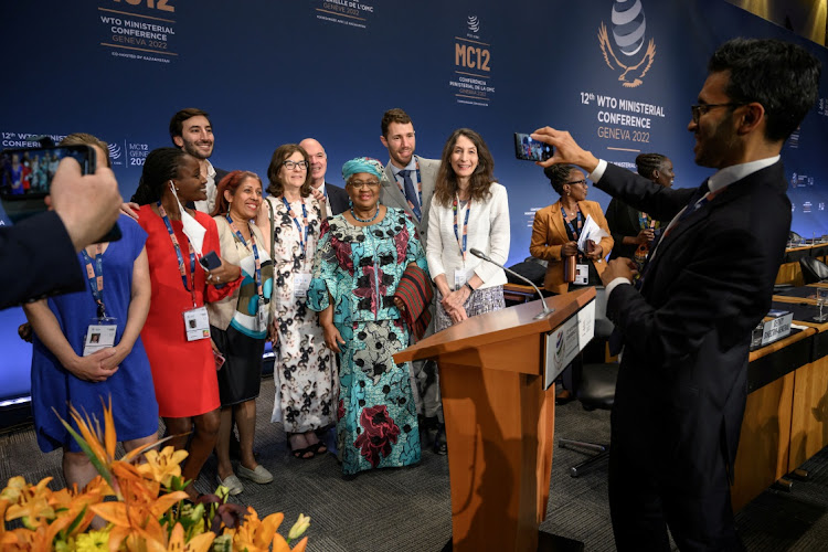 World Trade Organization Director-General Ngozi Okonjo-Iweala poses with delegates after the closing session of a ministerial conference at the WTO headquarters in Geneva, Switzerland on June 17 2022.