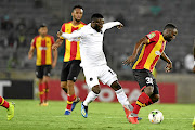 Orlando Pirates' Augustine Mulenga challenges Franck Nom of Esperance  during their first CAF Champions League match two weeks ago. The Tunisian giants won  2-0  behind  closed doors at  Stade Olympique de Rades in Tunis yesterday. /Lefty Shivambu/Gallo Images