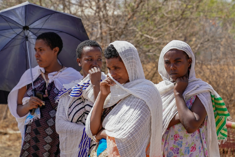 Agere Getnet and several widows mourn their loved ones at the edge of the mass graves at Abune Aregawi Ethiopian Orthodox Church on March 5, 2021 in Mai Kadra, Ethiopia. Ms. Getnet was leaving the graves of her husband, his younger brother and nephew, who were all killed during the attacks on Amhara in Mai Kadra from November 6 through 10th, 2020.