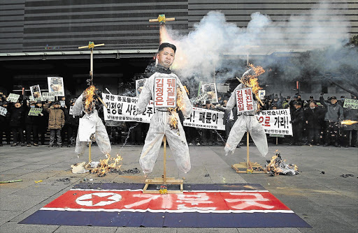 BURNING ANGER: South Koreans protest against North Korean leader Kim Jong-un Picture: