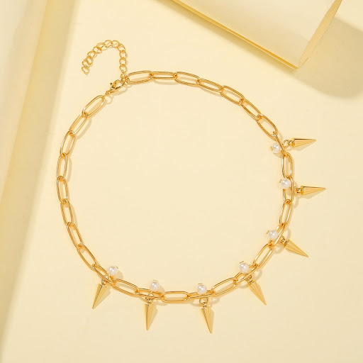 Title 3, Punk Pearl Metal Tapered Rivet Necklace. A bold...