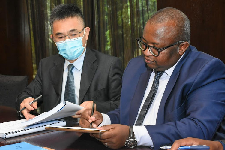 Contractor Jia Yangping and Housing and Urban development PS Charles Hinga during the signing of MoU for affordable housing at Mowlem on January 19, 2021.