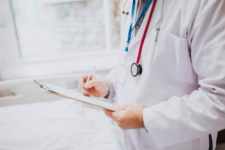 Focused physician taking patient's notes.