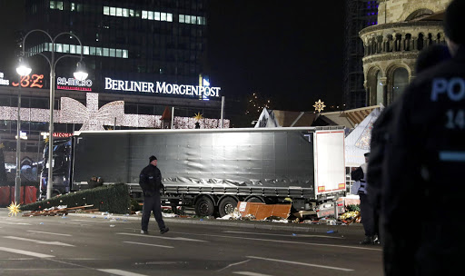 Police walk past a truck at a Christmas market in Berlin, Germany after a truck ploughed into the crowded Christmas market in the German capital. REUTERS/Pawel Kopczynski