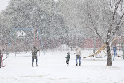 Residents come out to see and play in the snow at Jackson Dam in Alberton, south of Johannesburg.  