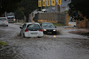 Motorists navigate a flooded section in Hurd Street in Newton Park.