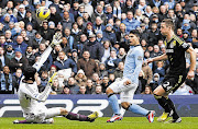 Manchester City's Sergio Aguero, centre, shoots past Chelsea's Petr Cech during the English Premier League match in Manchester on Sunday. The 2-0 defeat did not assist interim manager Rafael Benitez in his bid to restore the club's fortunes