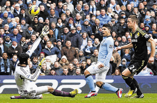 Manchester City's Sergio Aguero, centre, shoots past Chelsea's Petr Cech during the English Premier League match in Manchester on Sunday. The 2-0 defeat did not assist interim manager Rafael Benitez in his bid to restore the club's fortunes