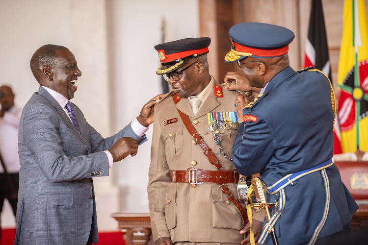 President William Ruto with Chief of Defence Forces Francis Ogolla (right) during the swearing in ceremony of new military officers at State House, Nairobi on March 9, 2024.