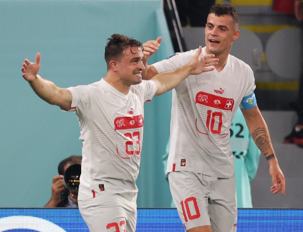 Switzerland's Xherdan Shaqiri celebrates scoring their first goal with Granit Xhaka.