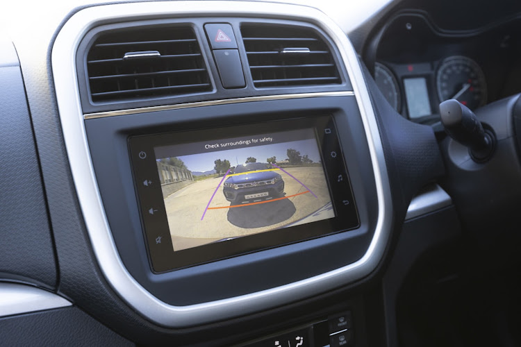 Touchscreen infotainment system is linked to a reverse camera.