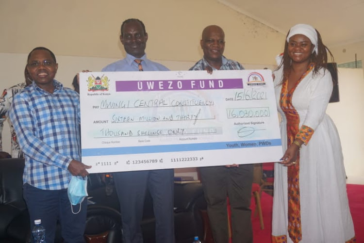 Mwingi Central MP Gideon Mulyungi and Kitui Woman Rep Irene Kasalu present a dummy Uwezo Fund cheque for Sh16.03 million