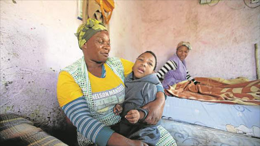 STILL SUFFERING: Olwethu Vimba says her daughter, Inam, suffered hypoxic damage to the brain due to delays in her birth at Holy Cross hospital. Inam is sitting with her grandmother, Nozipho Picture: MARK ANDREWS