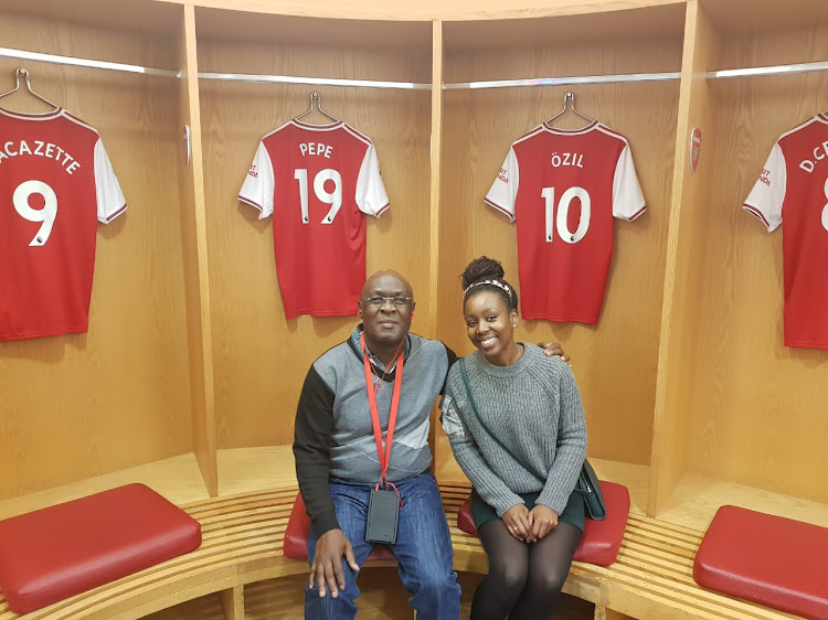 High Court judge Boaz Olao with his daughter when he toured Arsenal's Emirates Stadium in London.