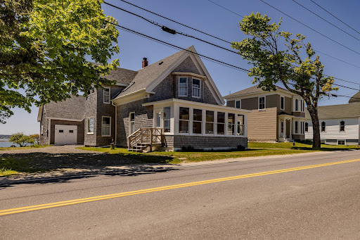 Gray house with garage and sunroom in this luxury house for sale in Jonesport ($549,000)