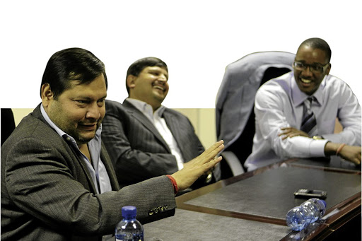 Duduzane Zuma, right, with Ajay and Atul Gupta in the offices of their newspaper, The New Age, in Midrand, Gauteng, in 2011.