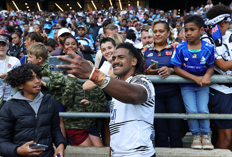 Selestino Ravutaumada of Fiji celebrates by taking a selfie with fans after their Summer International Test victory against England at Twickenham in London on Saturday.