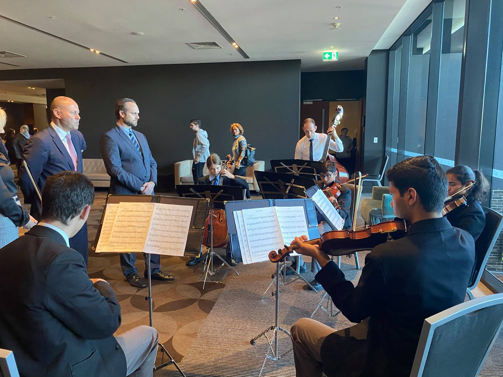 String Ensemble sitting in a semi circle playing for the Federal Treasurer Josh Frydenberg at Penrith Leagues Club