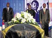 WELCOME HOME, NAT: Minister of Arts and Culture Nathi Mthethwa, SA National Editors' Forum executive director Mathatha Tsedu, and KwaZulu-Natal MEC for health Sibongiseni Dhlomo at King Shaka International Airport, Durban, yesterday for the repatriation from the US of the remains of Nat Nakasa