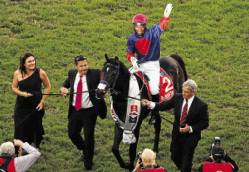 File Photo:S'manga Khumalo on Heavy Metal celebrates winning the 2013 Vodacom Durban July at Greyville racecourse in Durban on Saturday Photo: Gallo Images