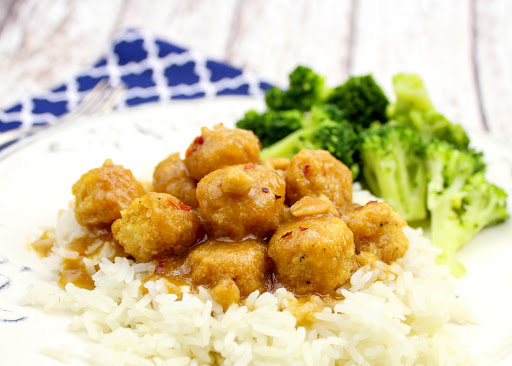 A plate of Jim's peanut butter chicken served over rice.