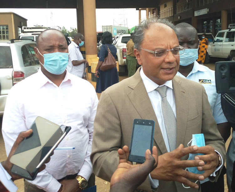 EAC and Regional Development PS Kevit Desai in Malaba on Tuesday October 13. He is with East African Business Council executive director Peter Mathuki.