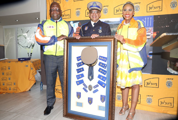 City of Johannesburg public safety MMC David Tembe and mayor Mpho Phalatse flank chief superintendent Wayne Minnaar.