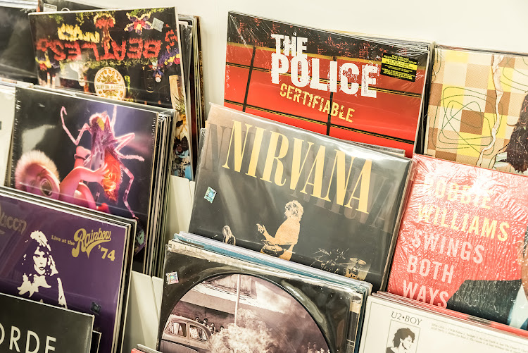 Vinyl records featuring the rock n roll greats: The Beatles, Queen, The Police.