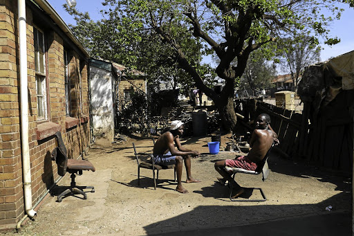 Brothers Parkson and Solomon Muvi in the yard of their home.