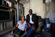 Melissa and Gibson Ncube pose for a portrait at their home in Alexandra, Johannesburg. The pair have been the victims of xenophobic attacks for over a year by a group of residents that claim that Gibson doesn’t have the correct paperwork to reside and own his property.