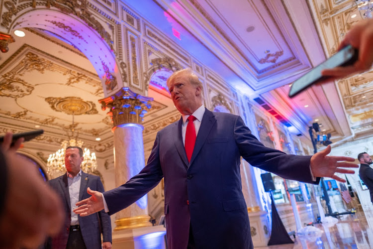 Former U.S. President Donald Trump talks to the press on the grounds of his Mar-a-Lago resort on midterm elections night in Palm Beach, Florida, U.S. November 8, 2022.