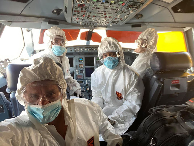 The flight crew in protective personnel equipment.