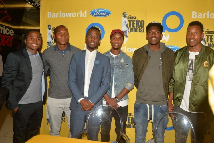 Siphiwe Tshabalala, Jackson Mabokgwane, Themba Zwane and Happy Jele pose with Teko Modise during the Launch of the book, The Curse of Teko Modise at Exclusive Books, Mall of Rosebank on November 29, 2017 in Johannesburg.