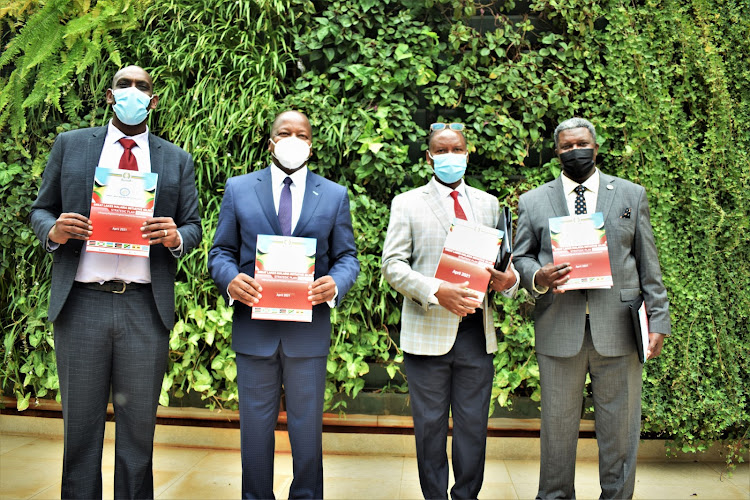 Society for Family Health Executive Director Manasseh Gihana, Health CS Mutahi Kagwe, EAC Secretariat Stephen Niyonzima during the launch of the Great Lakes 2021 -2025 strategic plan on June 25, 2021. The plan will address cross border transmission of Malaria in the great lakes region which comprise border areas of the 6 EAC countries and the DRC. Photo/MARGARET WANJIRU