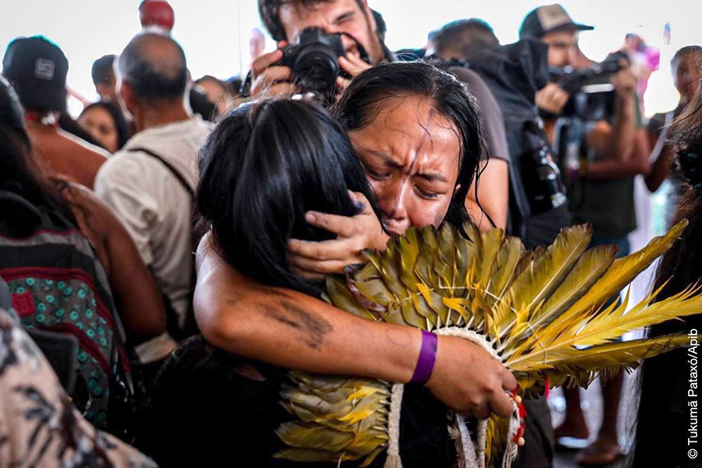 Indigenous women embrace in tearful joy on hearing the verdict