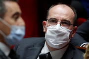 French Prime Minister Jean Castex, wearing a protective face mask, looks on as French Interior Minister Gerald Darmanin speaks during the questions to the government session at the National Assembly in Paris, France, December 1, 2020. 