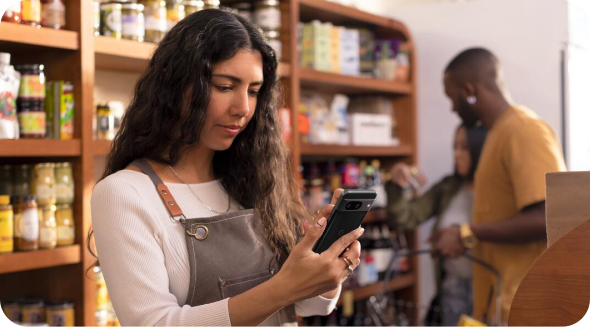 Woman in a shop working on her Pixel phone.