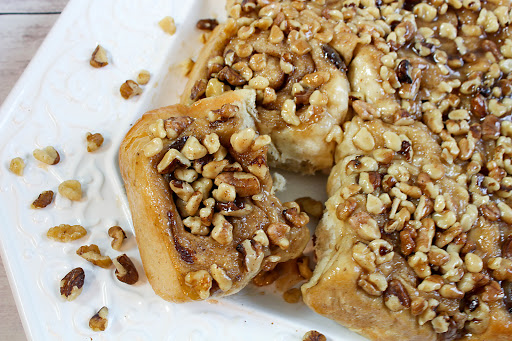 A banana nut sticky bun for the bread maker being pulled from the tray.